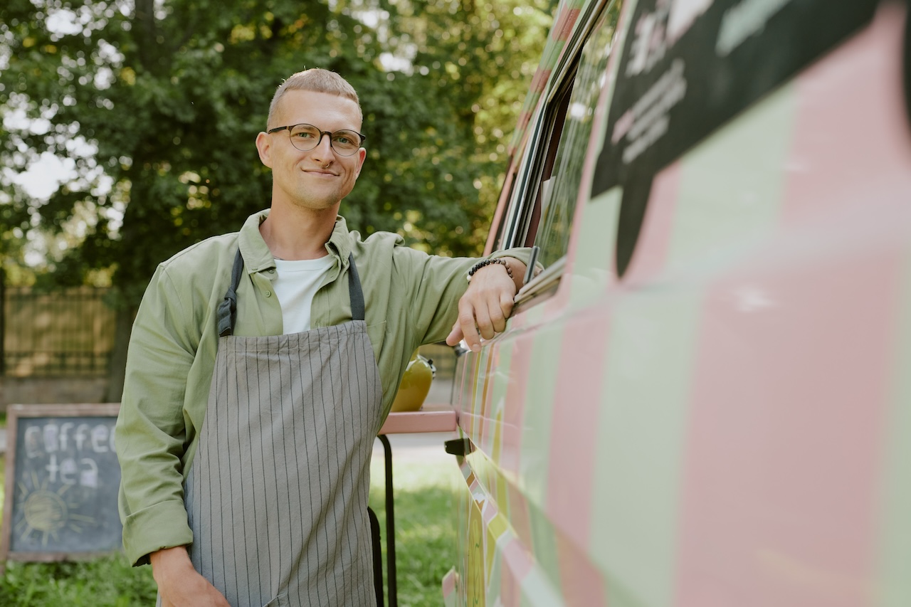 business owner standing in front of food truck
